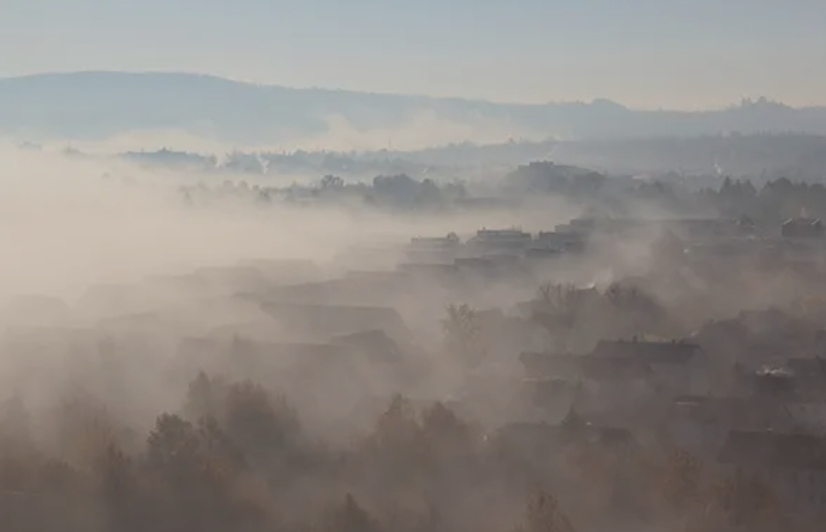 Aerial view of a hazy village landscape, demonstrating environmental challenges relevant to discussions in China's 'two sessions'.